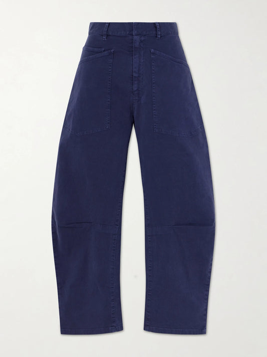 Image of a model wearing Pants. Product name - Shon Cotton-blend Twill Barrel-leg Pants in Blue colour by brand - Nili Lotan