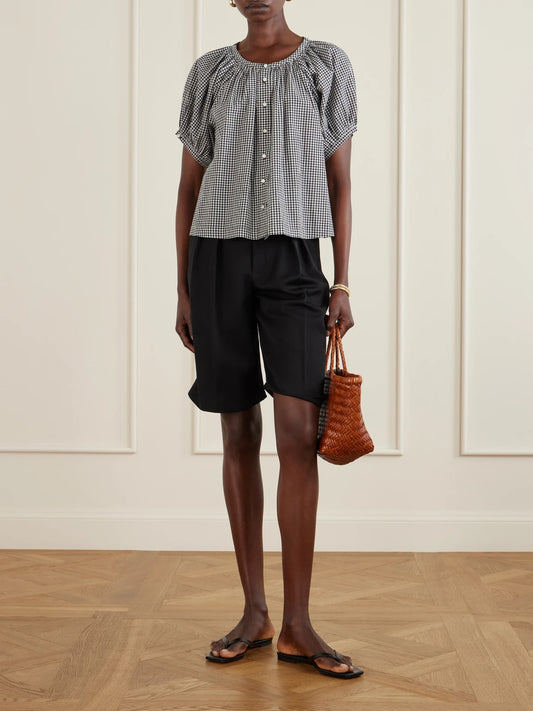 Image of a model wearing Tops. Product name - June Gathered Checked Cotton Blouse in Black colour by brand - DÔEN