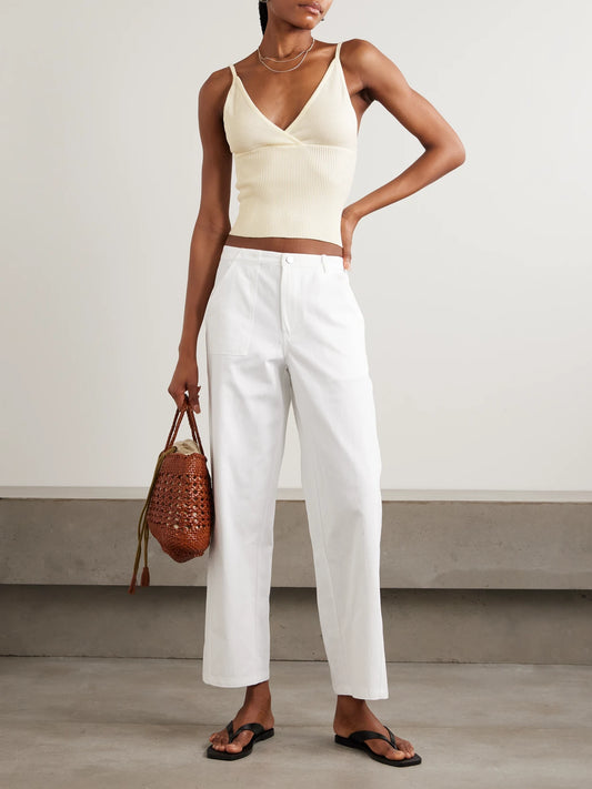 Image of a model wearing Tops. Product name - Cross Panel Cropped Ribbed Linen Top in Off-white colour by brand - Deiji Studios