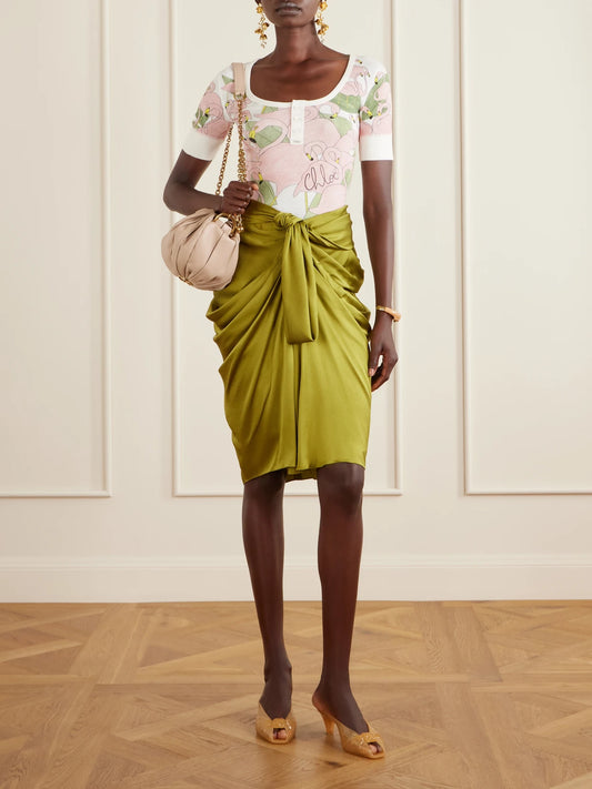 Image of a model wearing Skirts. Product name - Twist-front Silk-crepe De Chine Midi Skirt in Green colour by brand - Chloé
