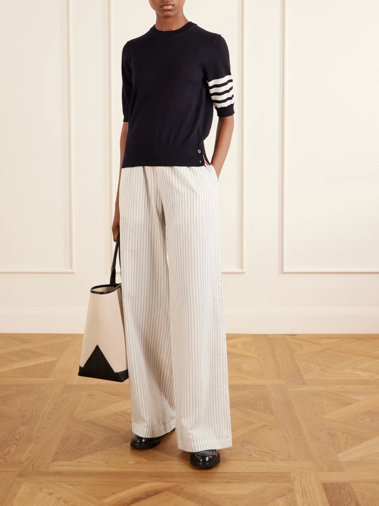Image of a model wearing Outerwear. Product name - Grosgrain-trimmed Striped Wool-blend Sweater in Navy colour by brand - Thom Browne