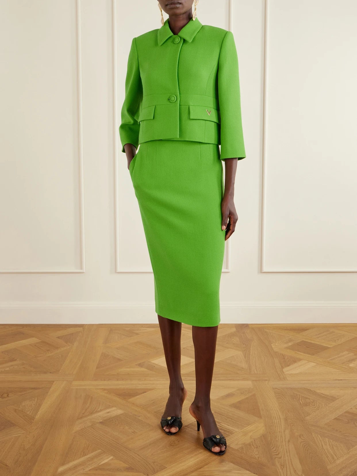 Image of a model wearing Skirts. Product name - Wool-crepe Midi Skirt in Bright green colour by brand - Valentino Garavani