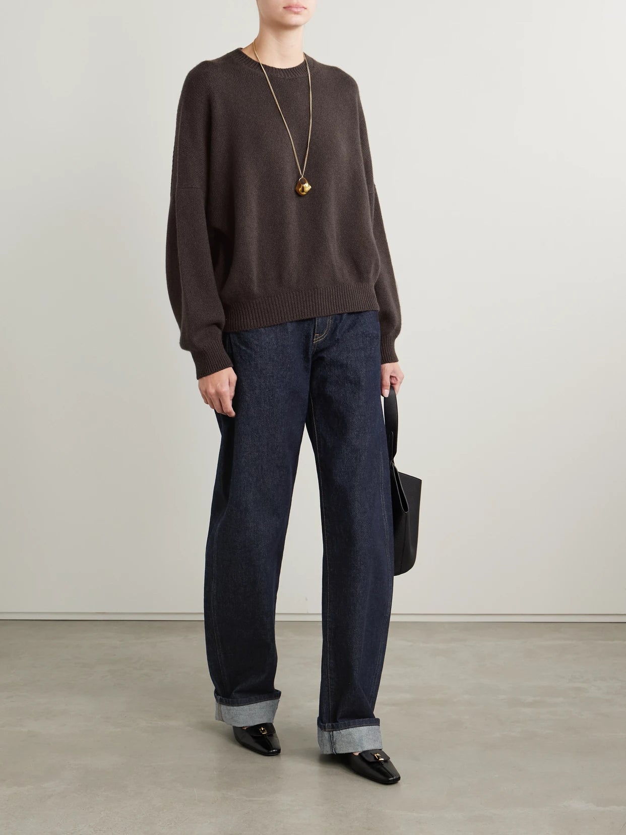 Image of a model wearing Outerwear. Product name - Margaux Oversized Cashmere Sweater in Dark brown colour by brand - KHAITE
