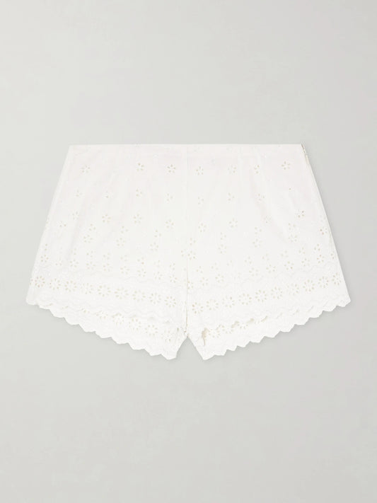 Image of a model wearing Shorts. Product name - Arda Broderie Anglaise Organic Cotton Shorts in White colour by brand - DÔEN