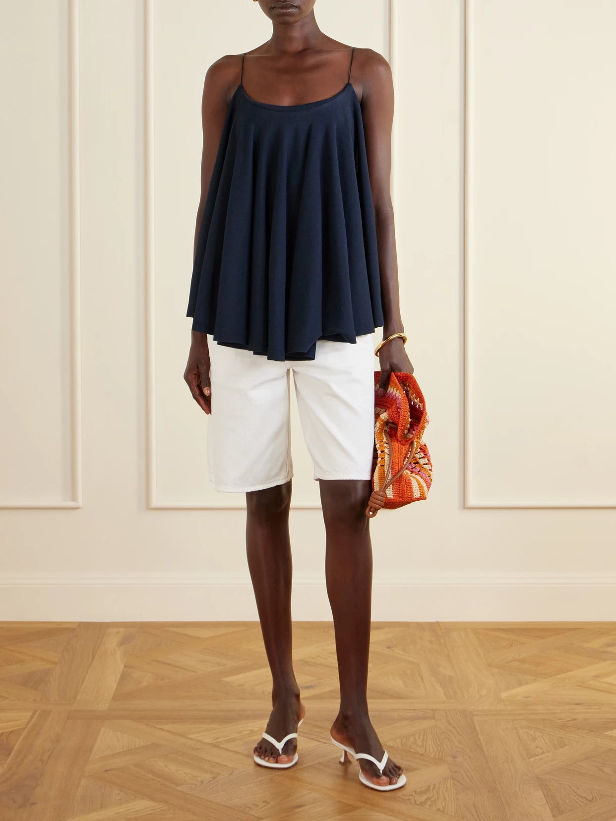 Image of a model wearing Tops. Product name - Le Haut Voile Open-back Jersey Top in Navy colour by brand - Jacquemus