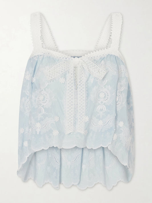 Image of a model wearing Tops. Product name - Kaila Cropped Asymmetric Bow-detailed Embroidered Silk-blend Voile Top in Blue colour by brand - Miguelina