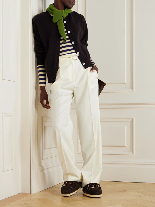 Image of a model wearing Pants. Product name - Pleated Wool-gabardine Wide-leg Pants in Cream colour by brand - Moncler