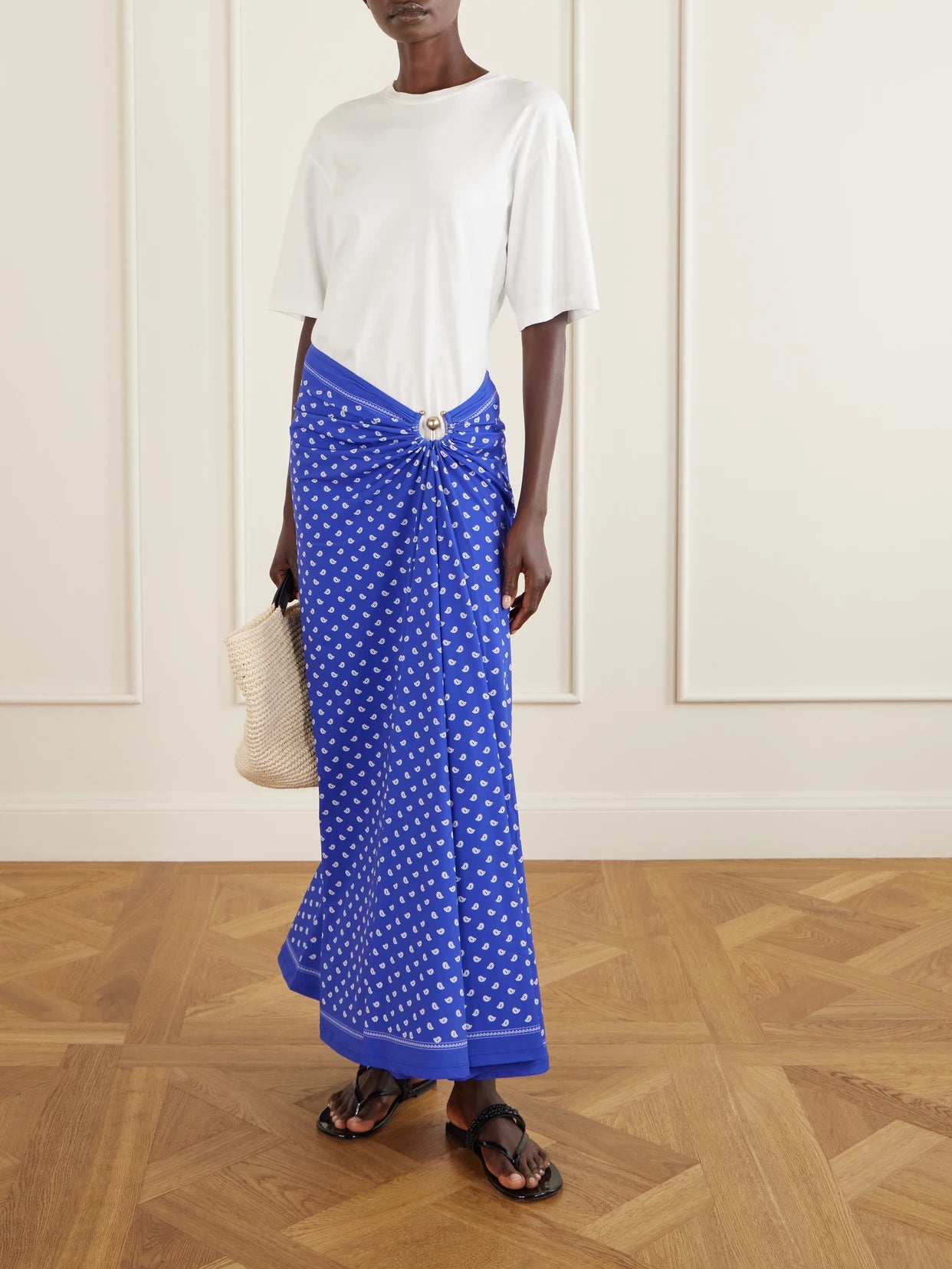 Image of a model wearing Skirts. Product name - Orbit Embellished Ruched Printed Stretch-jersey Maxi Skirt in Purple colour by brand - Christopher Esber