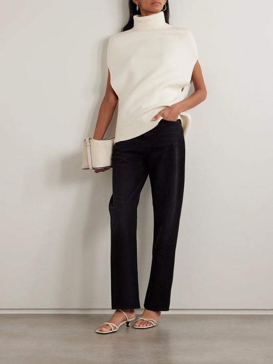 Image of a model wearing Outerwear. Product name - Oversized Knitted Wool Turtleneck Tank in White colour by brand - TOTEME