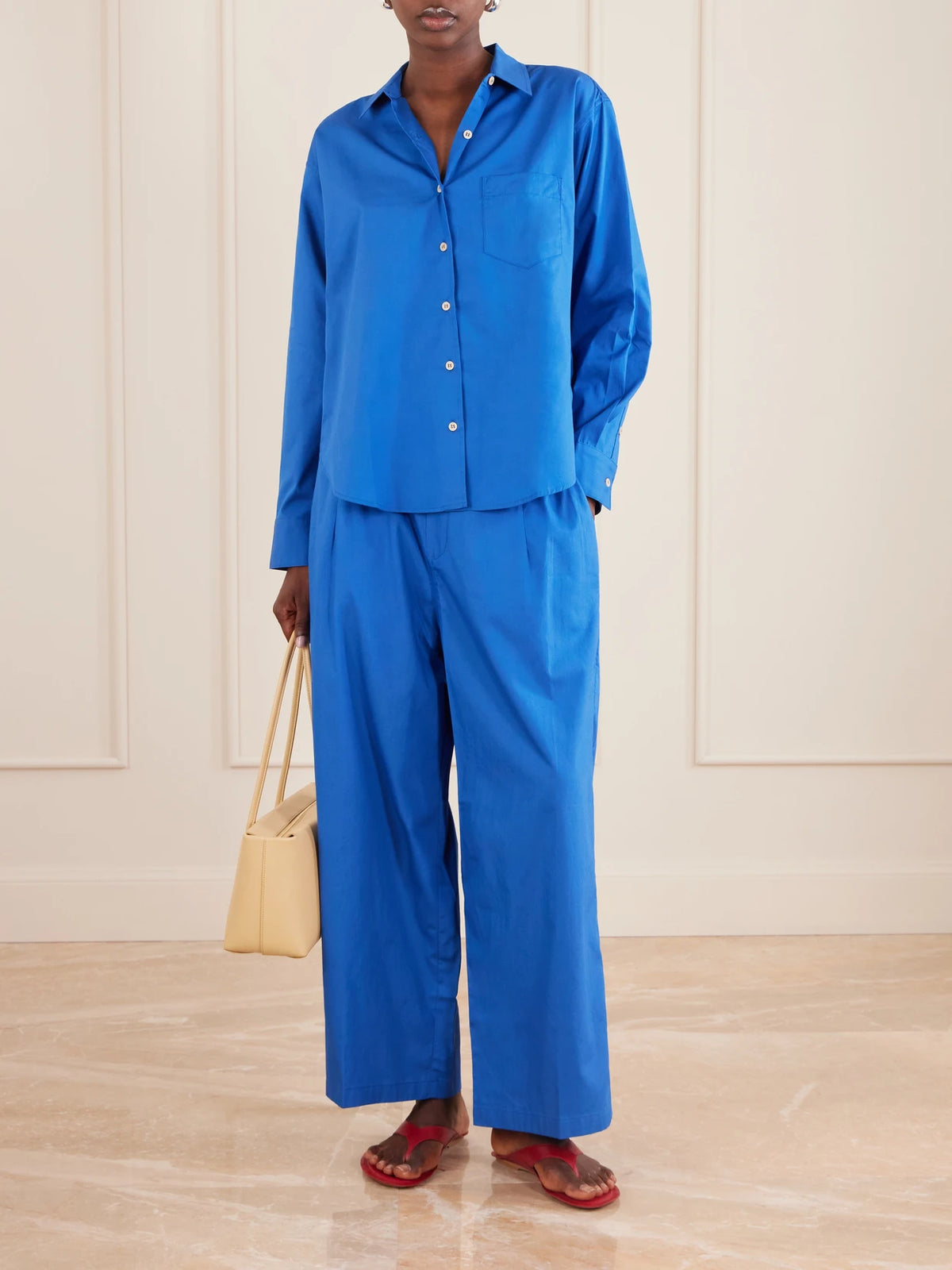 Image of a model wearing Tops. Product name - The Logo Weekend Cotton Shirt in Royal blue colour by brand - Jamie Haller
