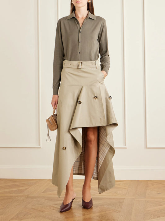 Image of a model wearing Skirts. Product name - Heather Belted Asymmetric Cotton-gabardine Midi Skirt in Beige colour by brand - Burberry