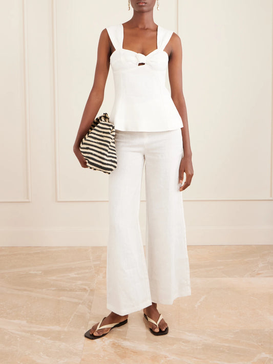 Image of a model wearing Tops. Product name - Pallida Linen Top in White colour by brand - Faithfull