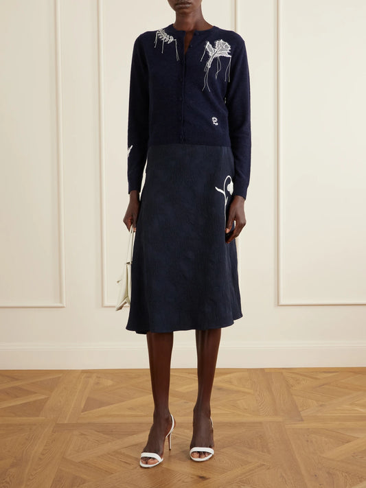 Image of a model wearing Skirts. Product name - Asymmetric Floral-jacquard Cotton-blend Midi Skirt in Navy colour by brand - Erdem