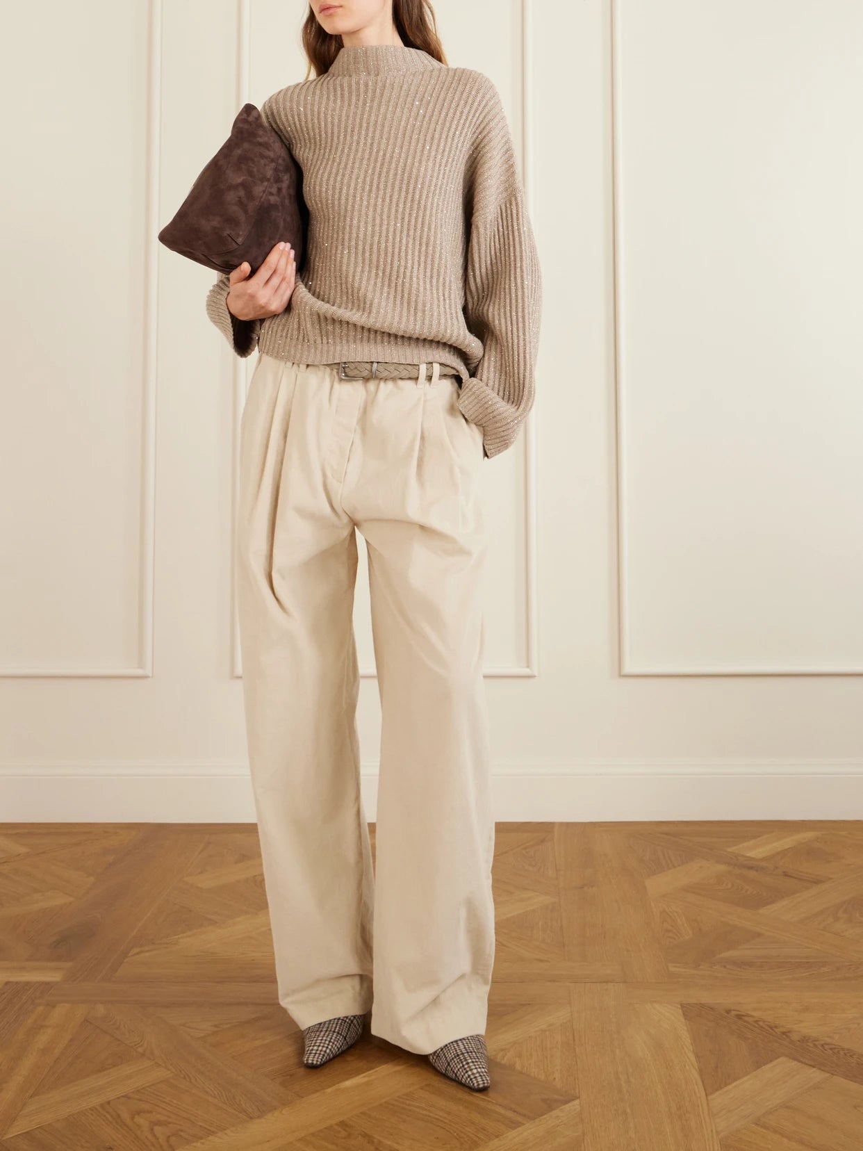 Image of a model wearing Pants. Product name - Pleated Cotton, Lyocell And Cashmere-blend Corduroy Wide-leg Pants in Cream colour by brand - Brunello Cucinelli