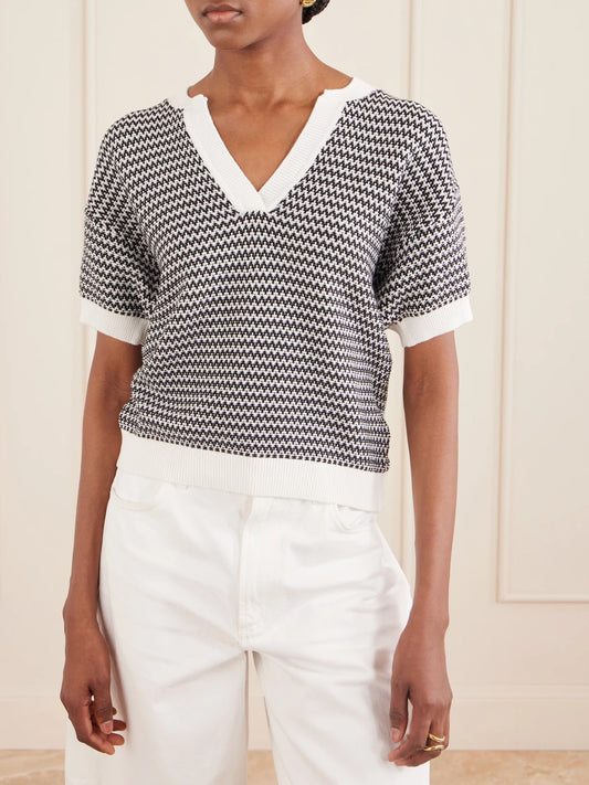 Image of a model wearing Outerwear. Product name - Dora Striped Knitted Cotton Top in Black colour by brand - Varley