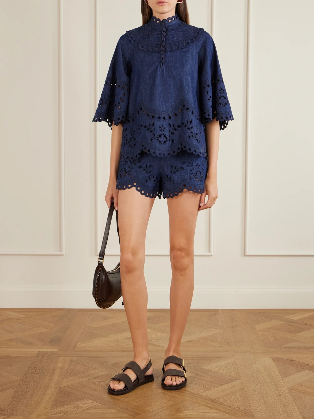 Image of a model wearing Shorts. Product name - Mahon Broderie Anglaise Denim Shorts in Blue colour by brand - Zimmermann