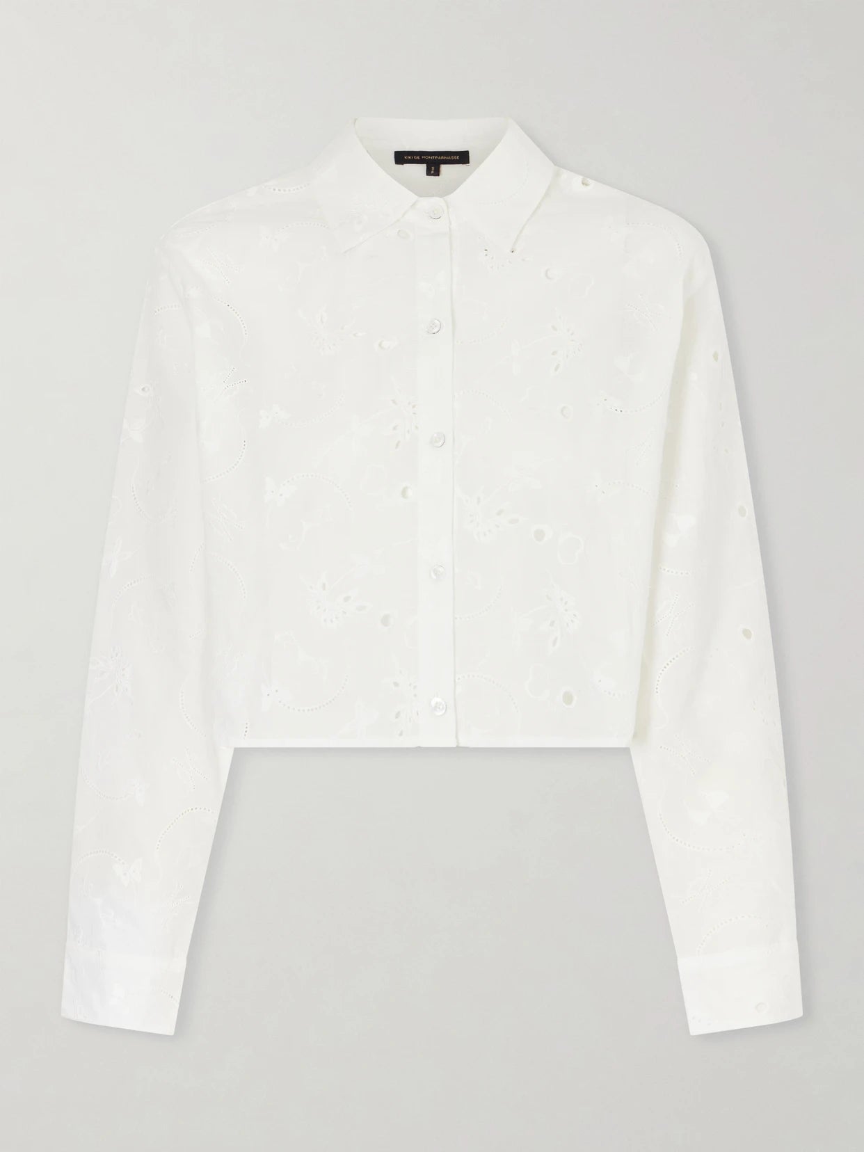 Image of a model wearing Tops. Product name - Simone Cropped Broderie Anglaise Cotton Shirt in Ivory colour by brand - Kiki de Montparnasse