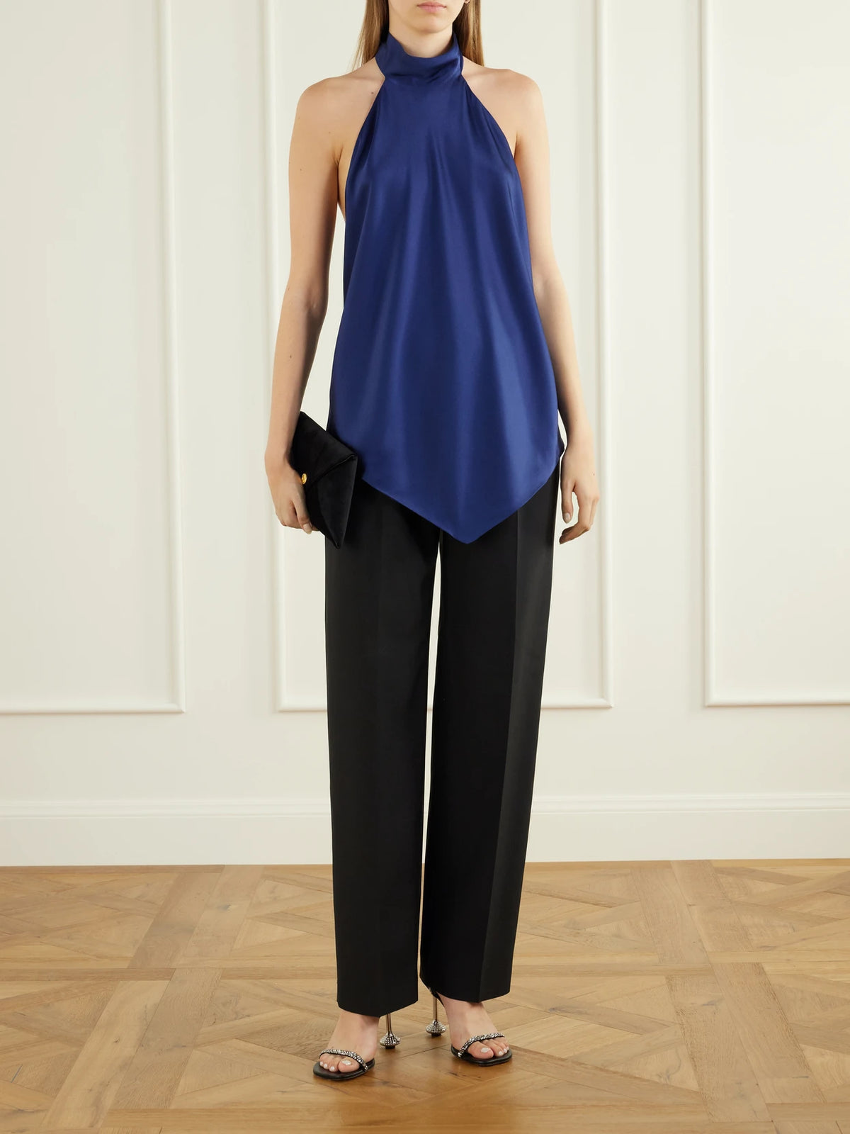 Image of a model wearing Tops. Product name - Backless Satin Halterneck Blouse in Navy colour by brand - Stella McCartney