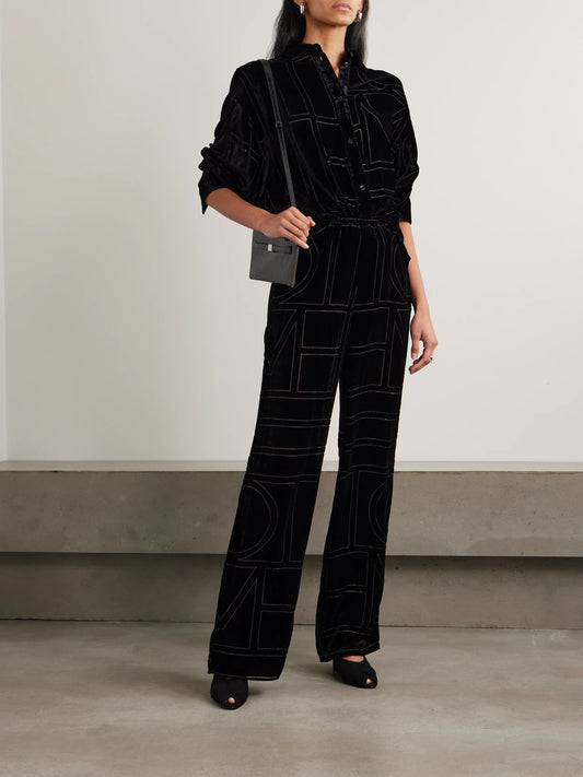 Image of a model wearing Pants. Product name - Devoré-velvet Wide-leg Pants in Black colour by brand - TOTEME