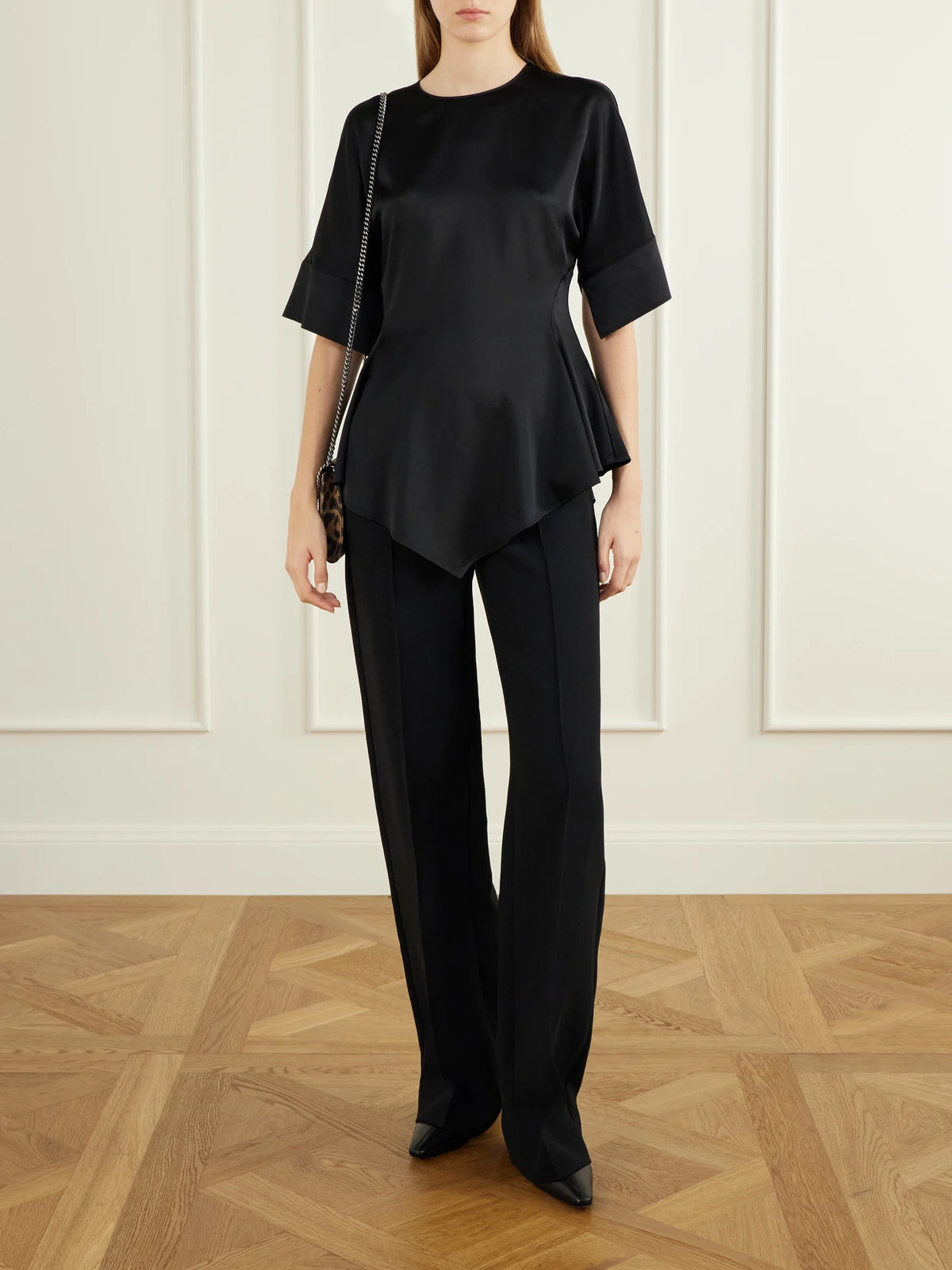 Image of a model wearing Tops. Product name - Satin Blouse in Black colour by brand - Stella McCartney