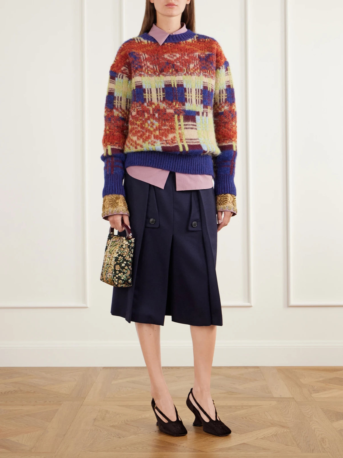 Image of a model wearing Skirts. Product name - Pleated Wool And Cotton-blend Midi Skirt in Navy colour by brand - Dries Van Noten