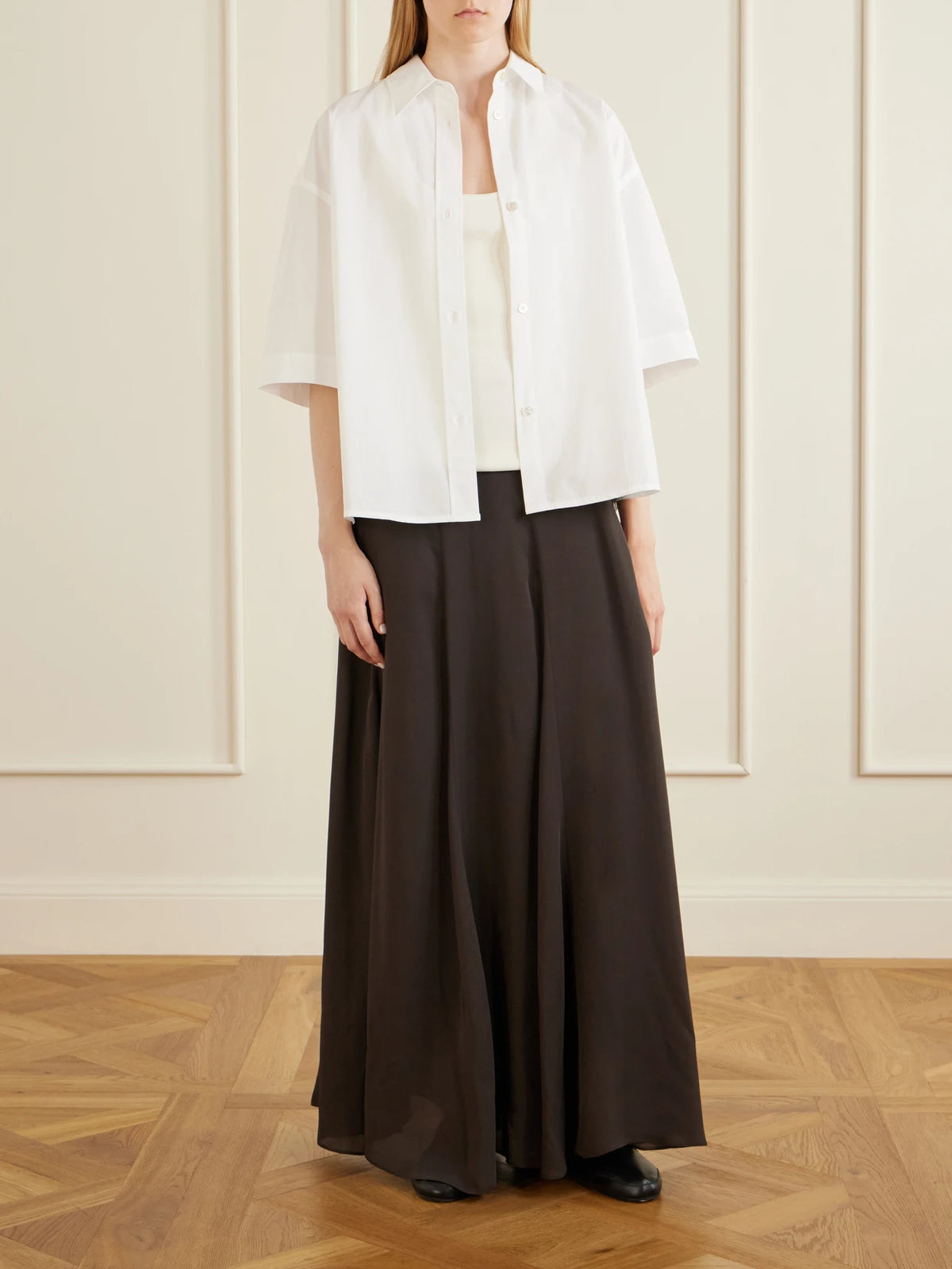 Image of a model wearing Tops. Product name - Toco Cotton-poplin Shirt in White colour by brand - Studio Nicholson