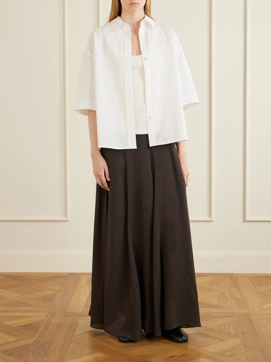 Image of a model wearing Tops. Product name - Toco Cotton-poplin Shirt in White colour by brand - Studio Nicholson