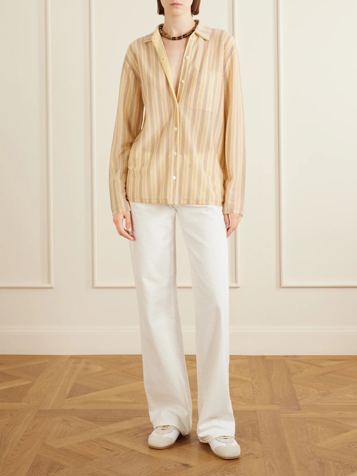 Image of a model wearing Tops. Product name - Showtime Striped Cashmere Shirt in Yellow colour by brand - Guest In Residence