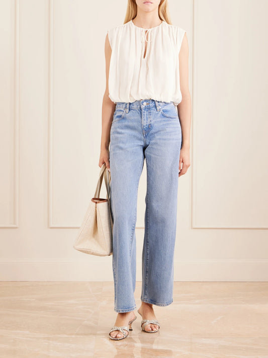 Image of a model wearing Tops. Product name - Wave Cropped Silk Top in Cream colour by brand - FRAME