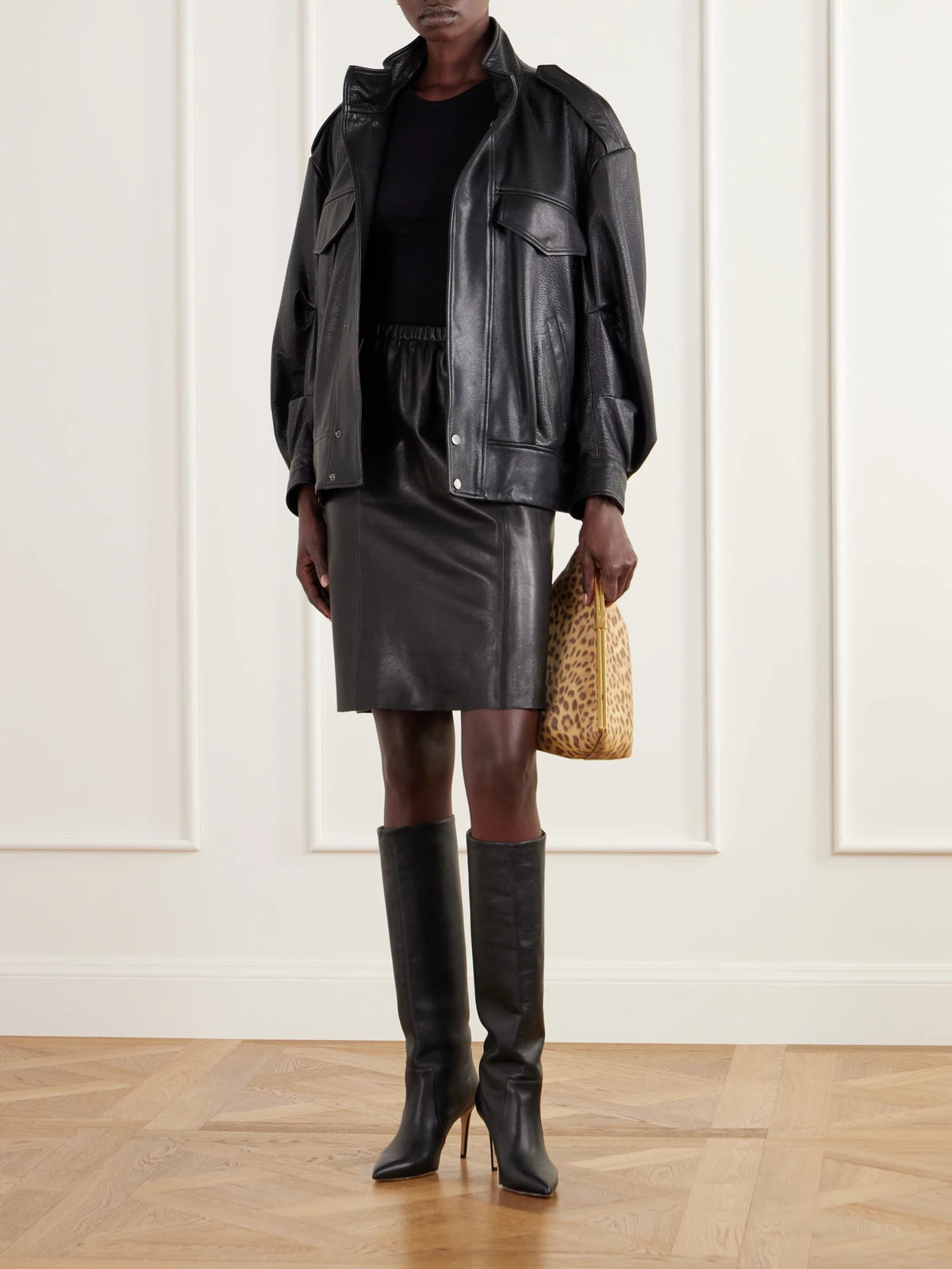 Image of a model wearing Skirts. Product name - Sabella Paneled Leather Midi Skirt in Black colour by brand - Nour Hammour