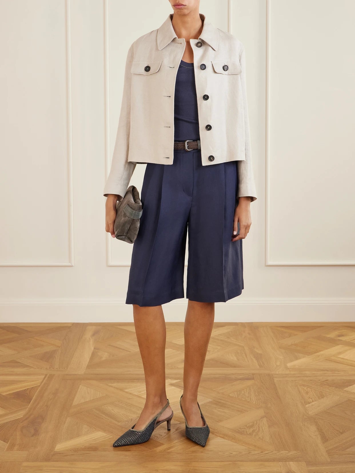 Image of a model wearing Shorts. Product name - Bead-embellished Pleated Twill Shorts in Navy colour by brand - Brunello Cucinelli