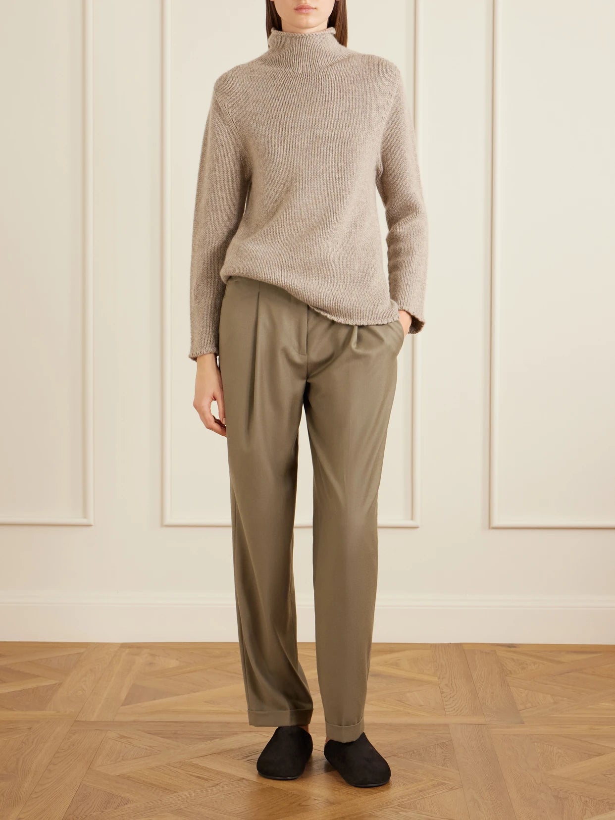 Image of a model wearing Outerwear. Product name - Mariam Turtleneck Cashmere Sweater in Taupe colour by brand - The Row