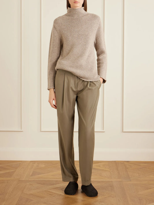 Image of a model wearing Outerwear. Product name - Mariam Turtleneck Cashmere Sweater in Taupe colour by brand - The Row