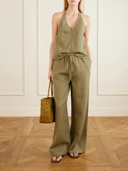 Image of a model wearing Tops. Product name - Corso Striped Linen Halterneck Top in Army green colour by brand - STAUD