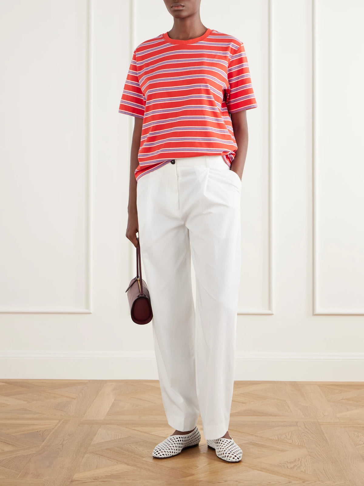 Image of a model wearing Tops. Product name - Boyfriend Striped Cotton-jersey T-shirt in Red colour by brand - La Ligne
