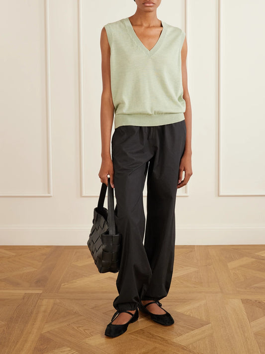 Image of a model wearing Outerwear. Product name - Amara Merino Wool Vest in Green colour by brand - SKALL