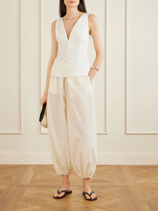 Image of a model wearing Pants. Product name - Almaya Cotton And Silk-blend Balloon Pants in Ivory colour by brand - Loulou de Saison
