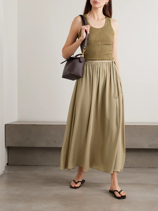 Image of a model wearing Skirts. Product name - Elba Tie-detailed Crepe De Chine Maxi Skirt in Army green colour by brand - Joseph