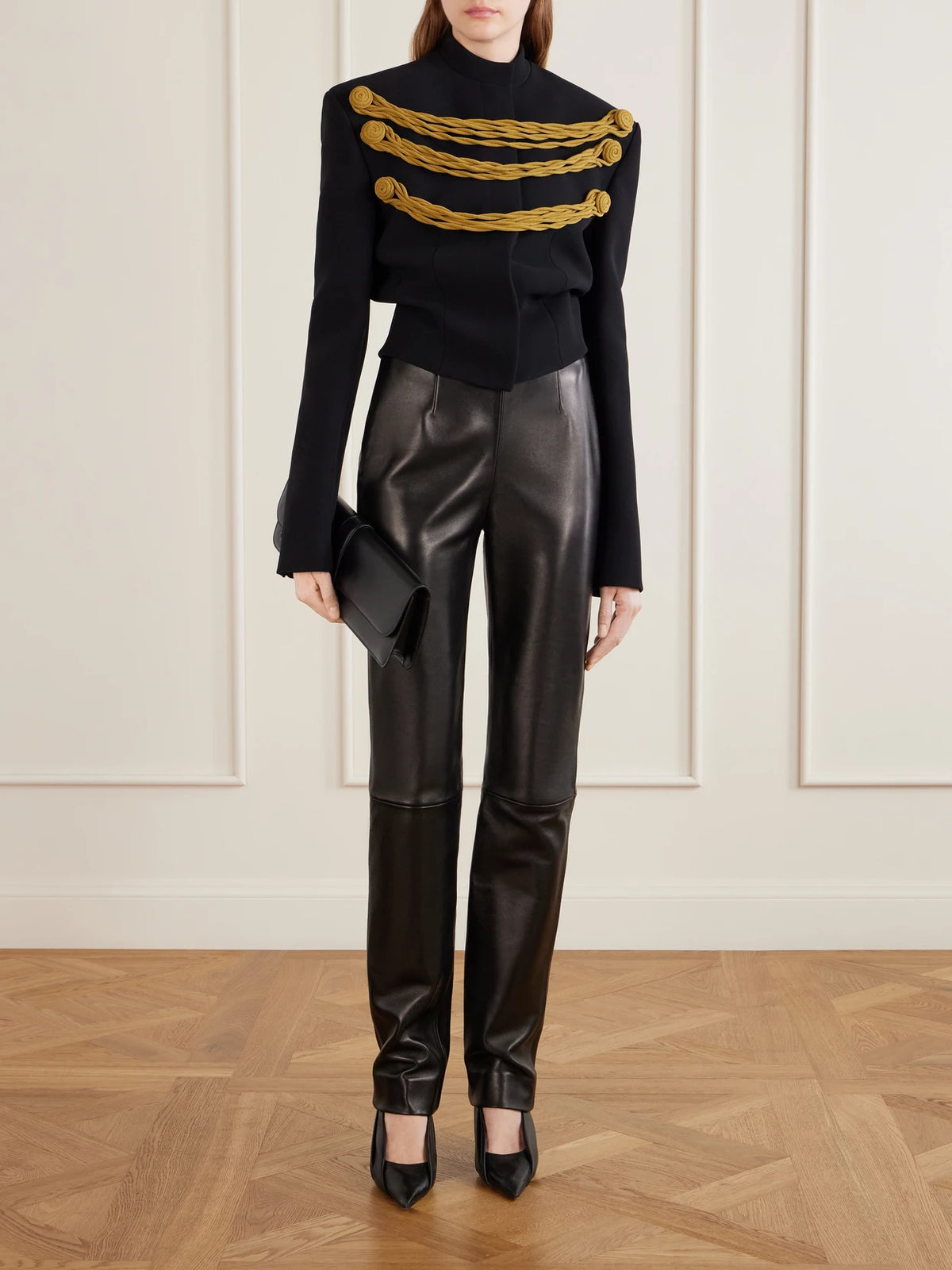 Image of a model wearing Pants. Product name - Ryden Leather Straight-leg Pants in Black colour by brand - KHAITE