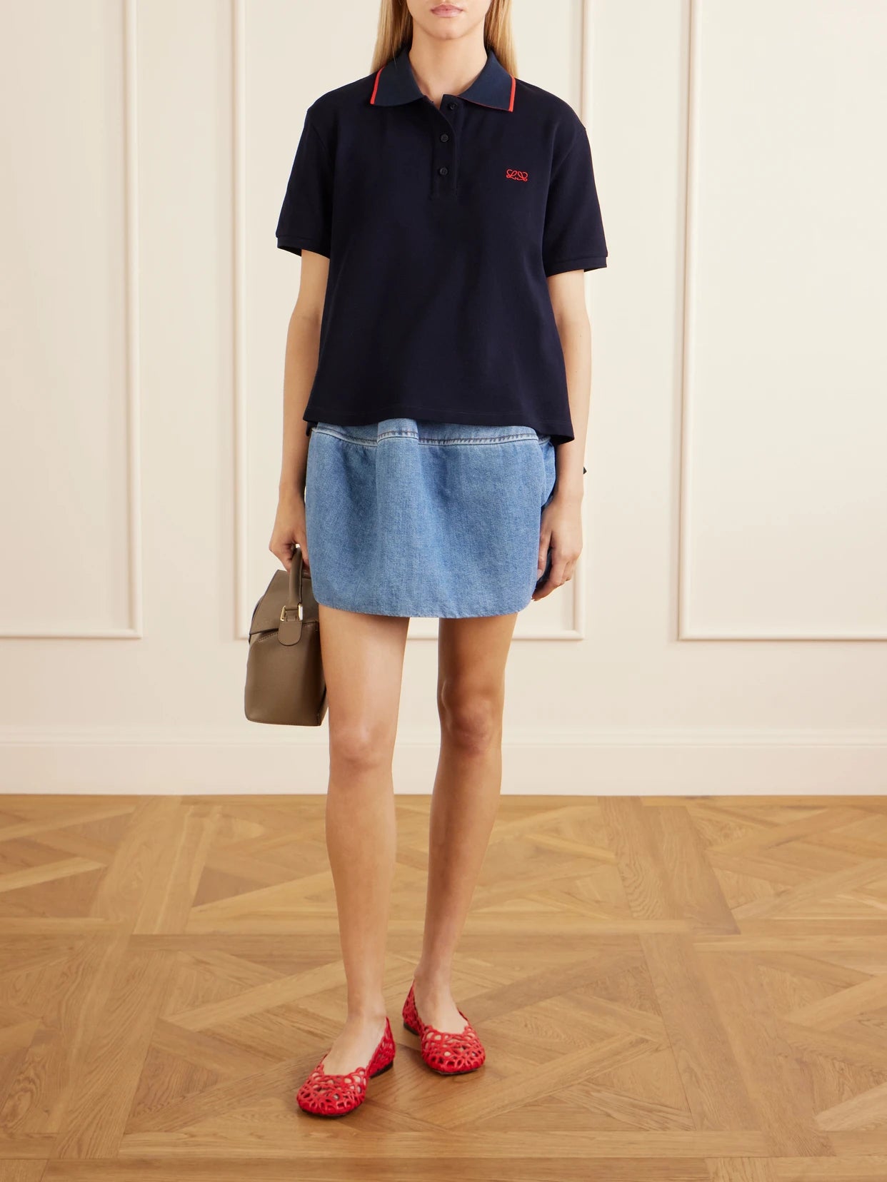Image of a model wearing Outerwear. Product name - Anagram-embroidered Cotton-piqué Polo Shirt in Navy colour by brand - LOEWE