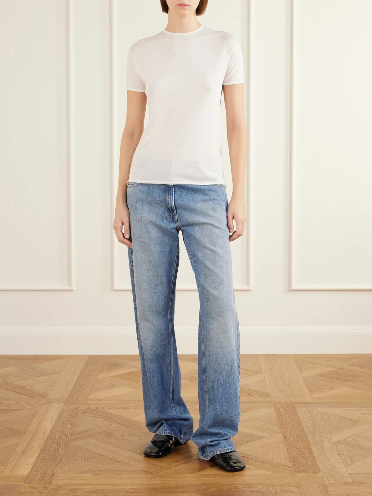 Image of a model wearing Tops. Product name - Bégonia Cotton-jersey T-shirt in Off-white, Black colour by brand - Calvin Klein Collection