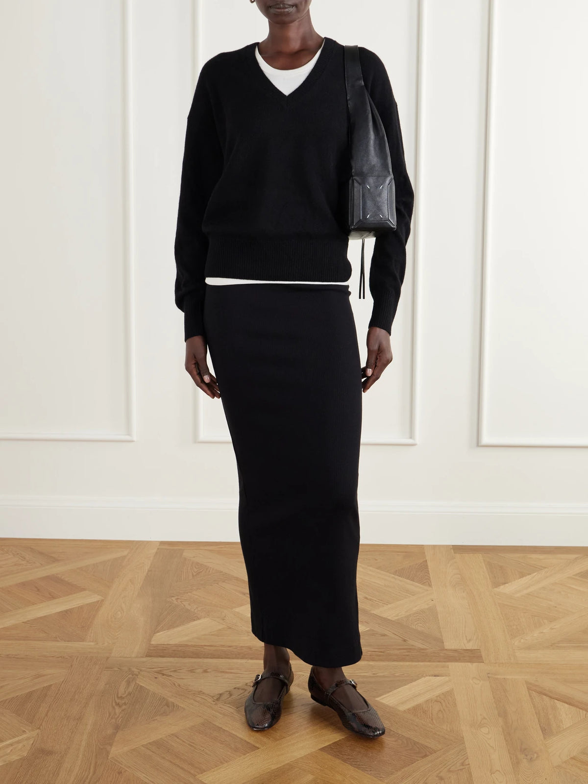 Image of a model wearing Outerwear. Product name - Marcel Cashmere Sweater in Black colour by brand - ÉTERNE