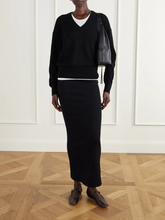 Image of a model wearing Outerwear. Product name - Marcel Cashmere Sweater in Black colour by brand - ÉTERNE