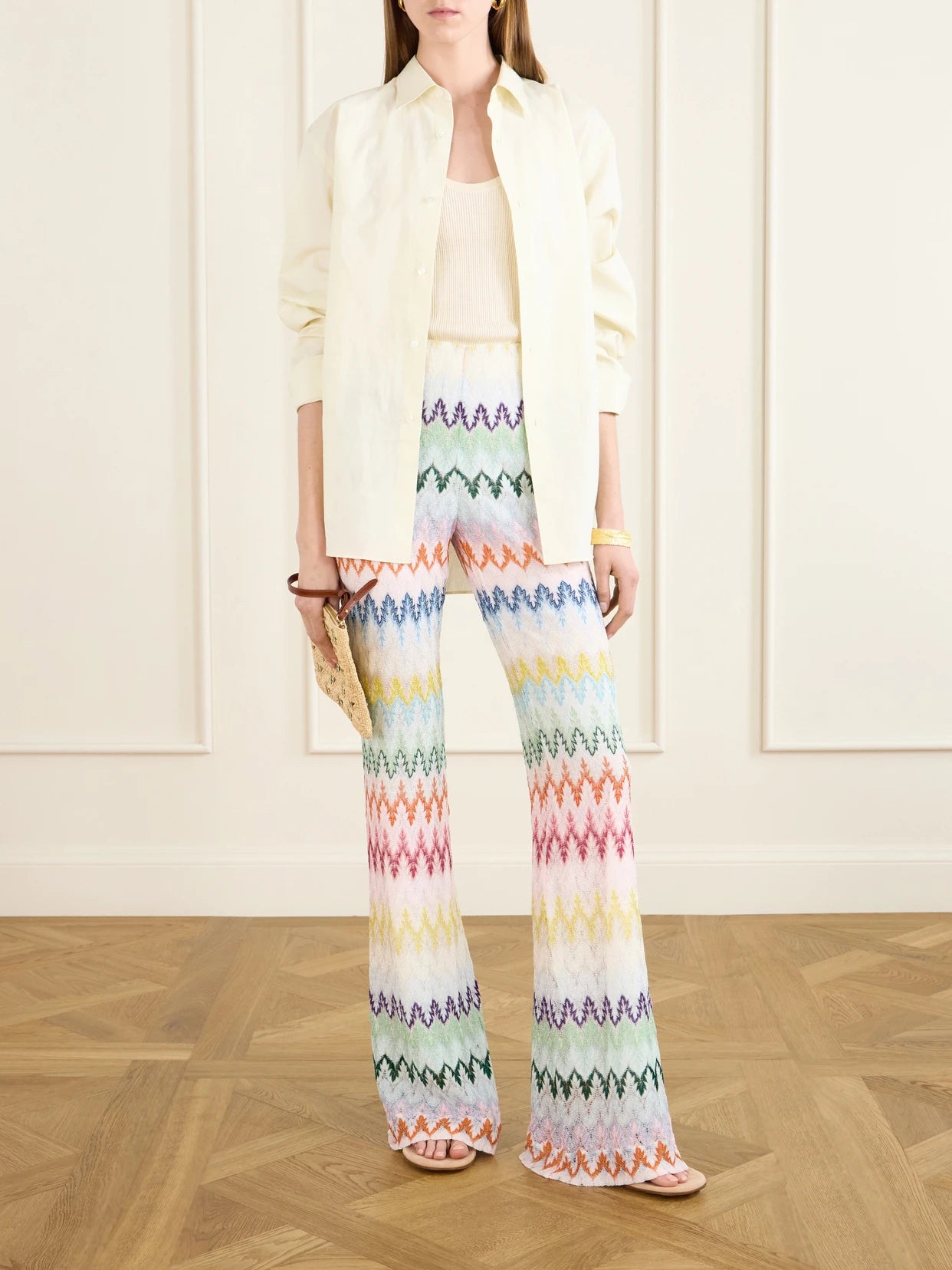 Image of a model wearing Pants. Product name - Striped Metallic Crochet-knit Flared Pants in White colour by brand - Missoni