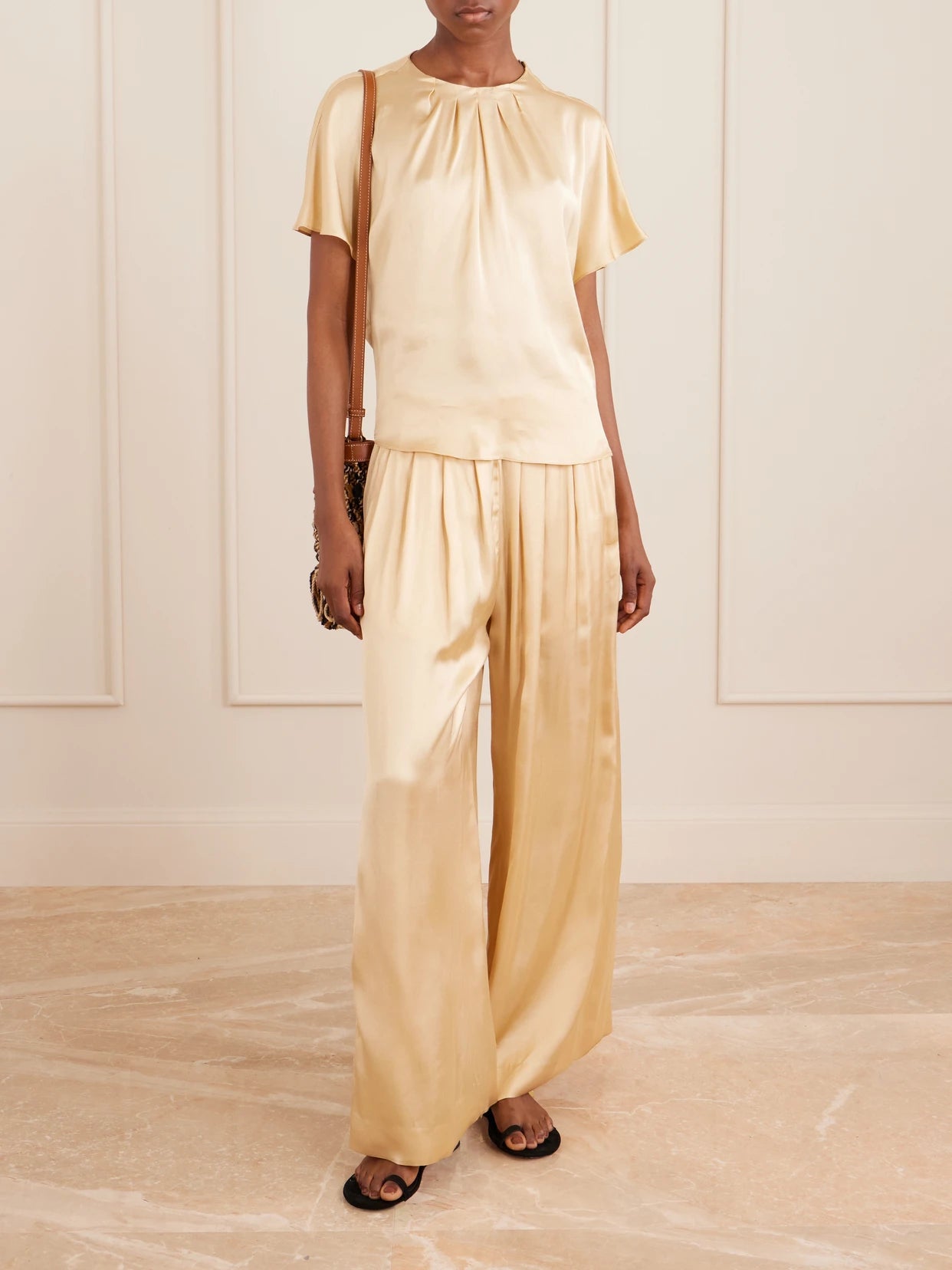 Image of a model wearing Pants. Product name - Nolia Satin Wide-leg Pants in Beige colour by brand - ISABEL MARANT