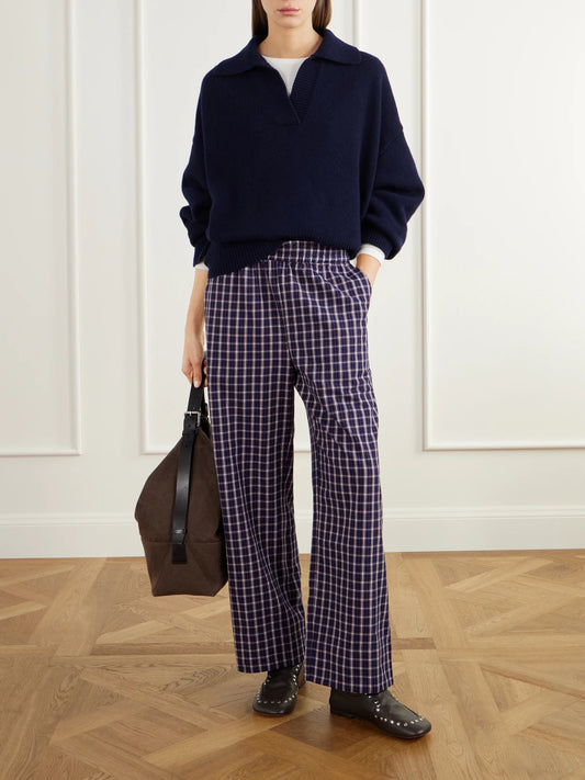 Image of a model wearing Outerwear. Product name - Dean Oversized Rib-trimmed Merino Wool Polo Sweater in Navy colour by brand - SKALL