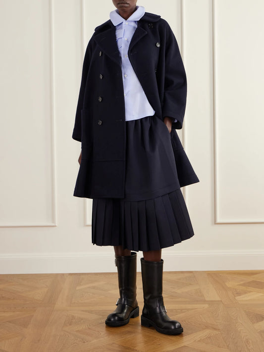 Image of a model wearing Skirts. Product name - Tiered Pleated Gabardine Midi Skirt in Navy colour by brand - Comme des Garçons GIRL