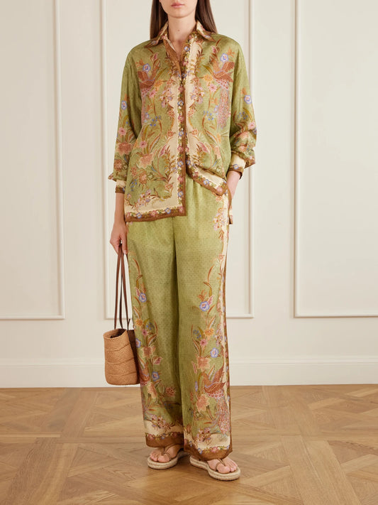 Image of a model wearing Pants. Product name - Indra Printed Silk Wide-leg Pants in Green colour by brand - Zimmermann