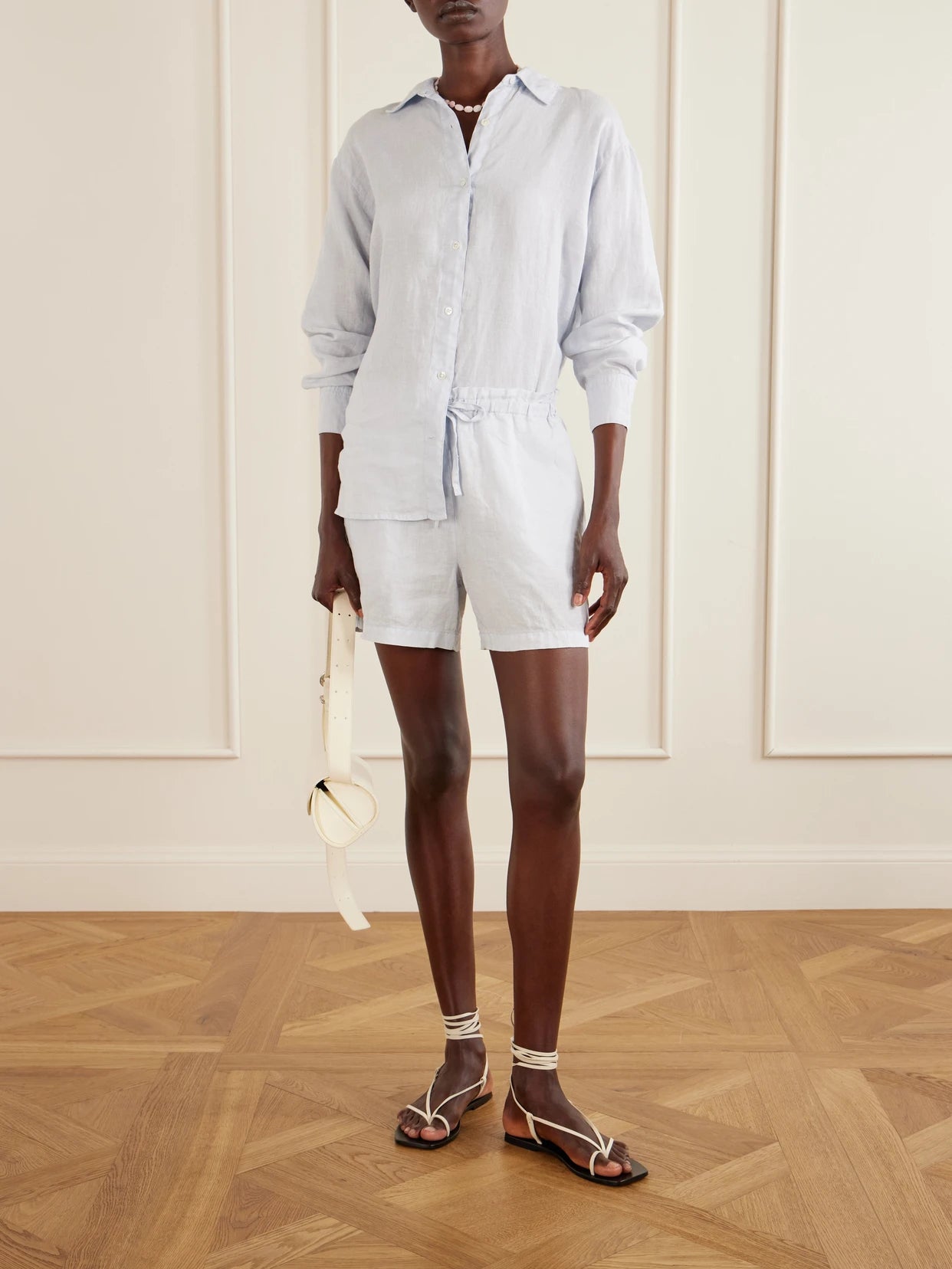 Image of a model wearing Shorts. Product name - Linen Shorts in Blue colour by brand - James Perse