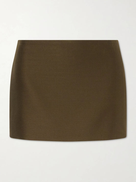 Image of a model wearing Skirts. Product name - Jett Wool And Silk-blend Cady Mini Skirt in Army green colour by brand - KHAITE